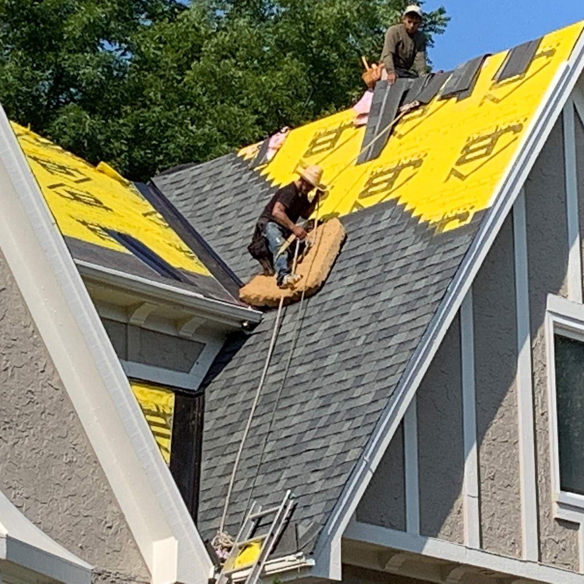 John Beal Roofing crew installing shingles on a St. Louis area roof